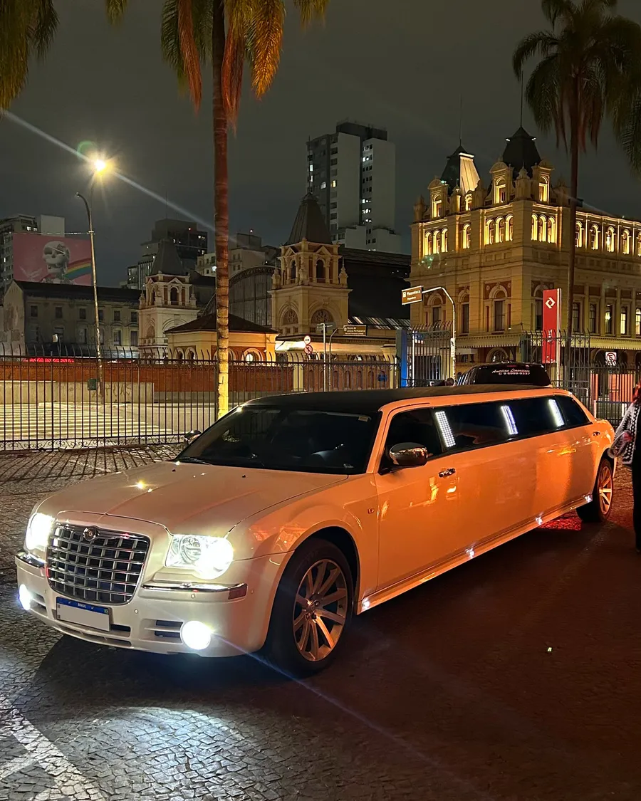Limousine Chrysler 300C branca em três quartos, sob iluminação noturna
